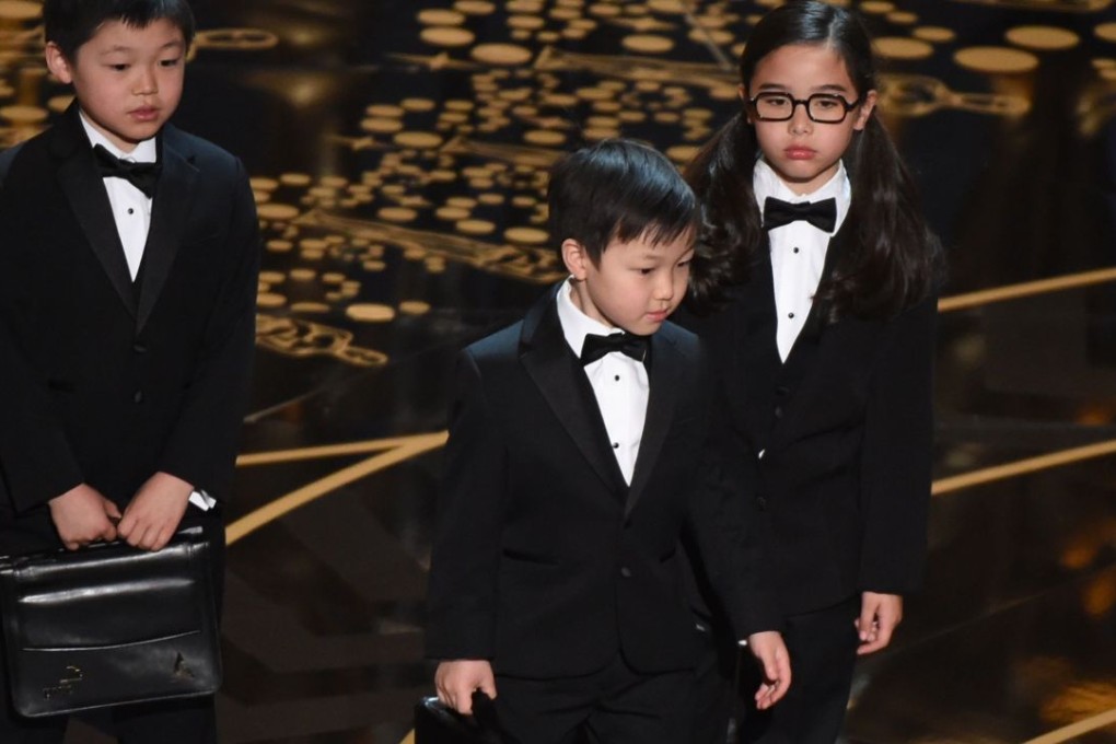 Asian children represent accountants from PricewaterhouseCoopers on stage at the 88th Oscars. Photo: AFP