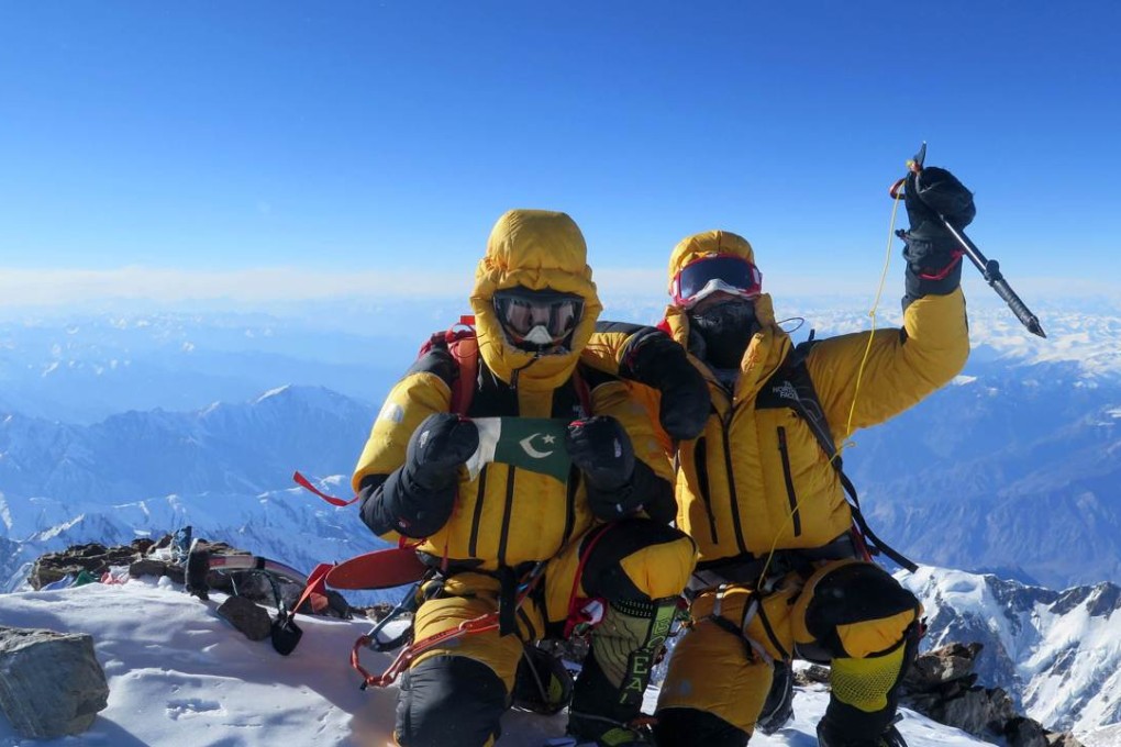 Italian climber Simone Moro (R) and Pakistani climber Ali Sadpara celebrate after scaling the peak of Nanga Parbat, known as “Killer Mountain” because of the number of people who have died attempting to summit it. Photo: AFP Photo/Marianna Zanatta Sports Marketing Management