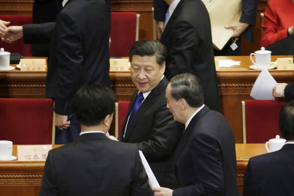 Chinese President Xi Jinping turns to listen to anti-graft boss Wang Qishan after the opening session of the Chinese People's Political Consultative Conference at the Great Hall of the People in Beijing. Photo: Reuters
