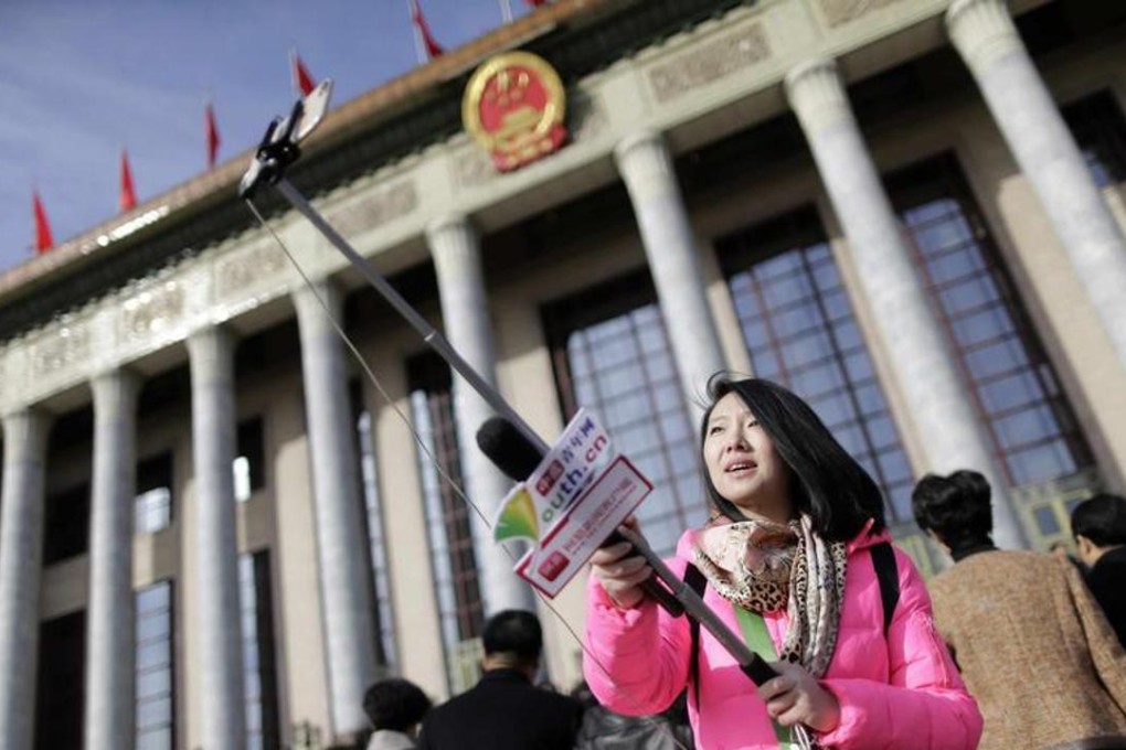 A journalist using a selfie stick outside the Great Hall of the People during last year’s National People’s Congress in Beijing. Photo: Reuters