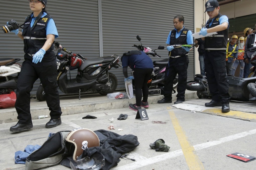 Thai police work at the scene of an attempted robbery of a gun shop in central Bangkok on Friday, March 4, 2016. Photo: AP