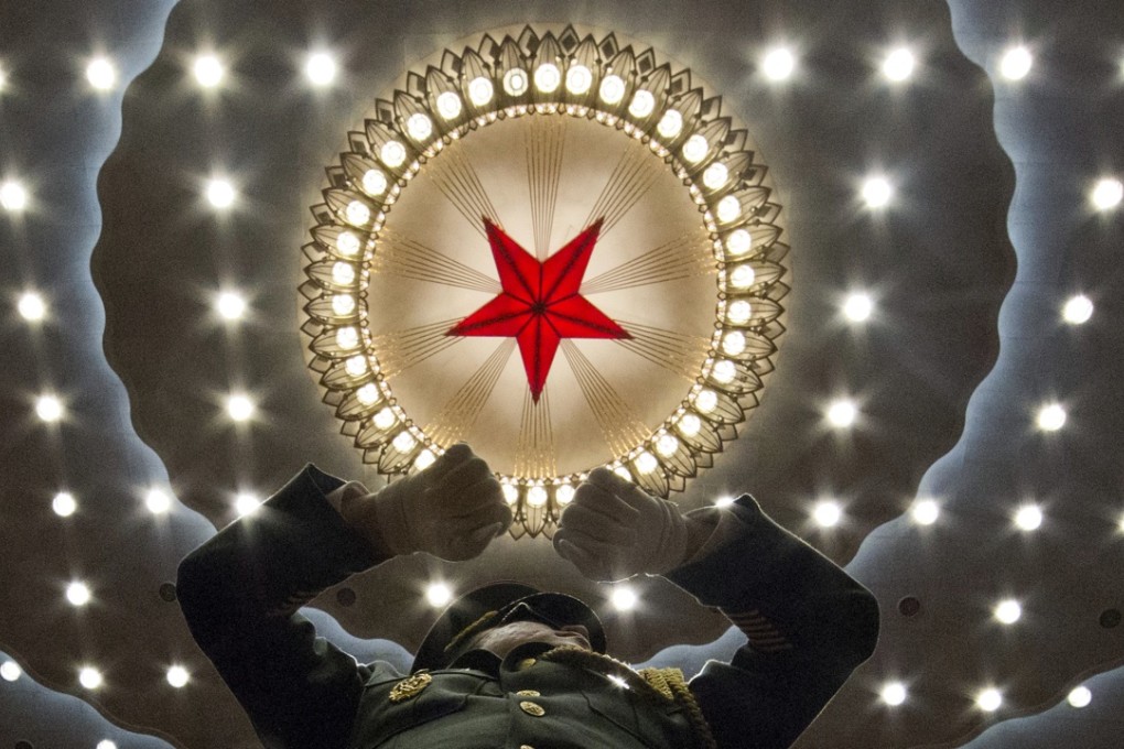A Chinese military band conductor leads the band at the opening session of the annual National People's Congress in Beijing's Great Hall of the People on Saturday. Photo: AP