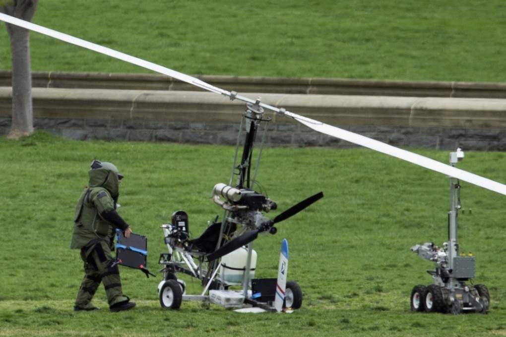 A member of the bomb squad checks an autogyro after a man landed on the West Lawn of the Capitol in Washington. Photo: AP