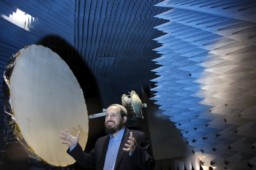 Co-founder of Israeli startup Skyfi, Raz Itzhaki Tamir, gestures during a demonstration in an anechoic chamber where the company performs tests on their development, the first self-correcting antenna that can turn mini-satellites into powerful transmitters covering the globe to provide worldwide internet access. Photo: Reuters