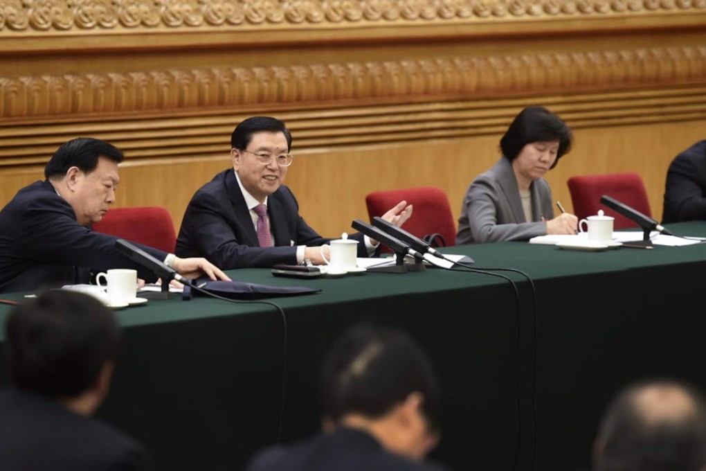 NPC chairman Zhang Dejiang (second from left) warns clashes such as Mong Kok riot could hurt Hong Kong’s economic development. Photo: Xinhua