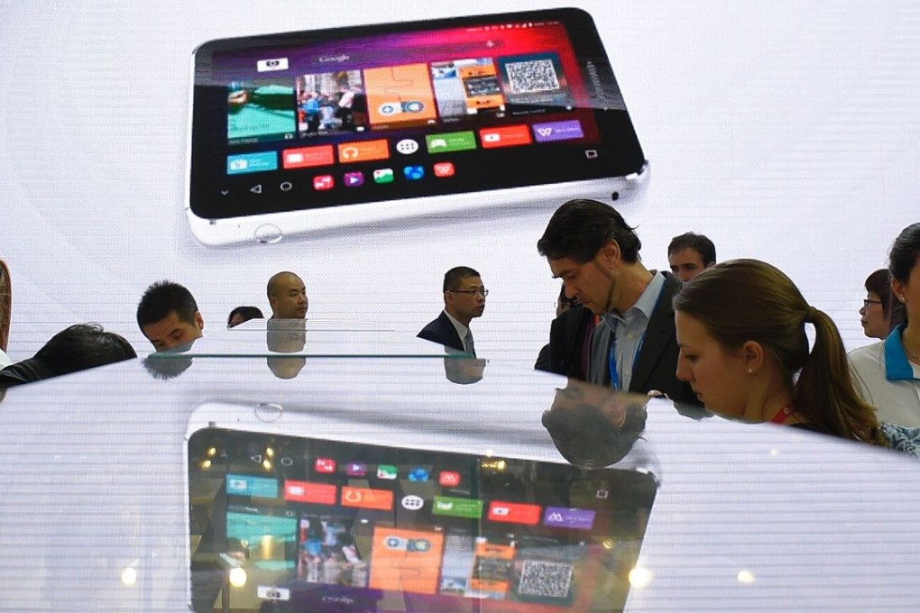 Visitors look at smartphones at the ZTE stand at the Mobile World Congress in Barcelona last month. Photo: AFP