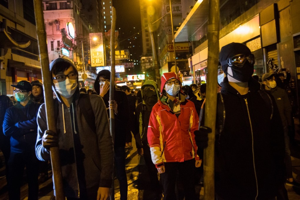 Rioters confront police during the Mong Kok riot. Of the 75 people arrested over the rioting, about half were jobless while others were employed in low-paid jobs as, for example, cooks and salesmen. Photo: Bloomberg