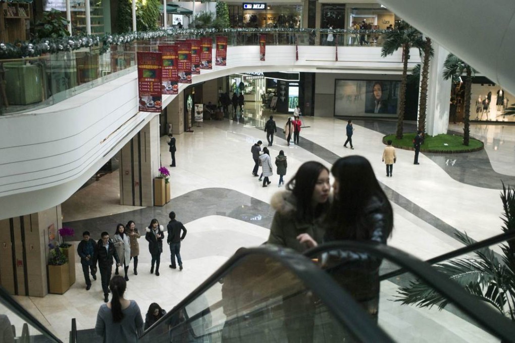 Visitors look around a shopping mall in Beijing. Photo: AFP