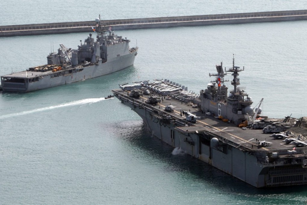 The amphibious assault vessel USS Bonhomme Richard (right) and the USS Ashland leave the port of Busan, South Korea, on March 7, 2016, to take part in a combined landing exercise with South Korean forces. Photo: EPA