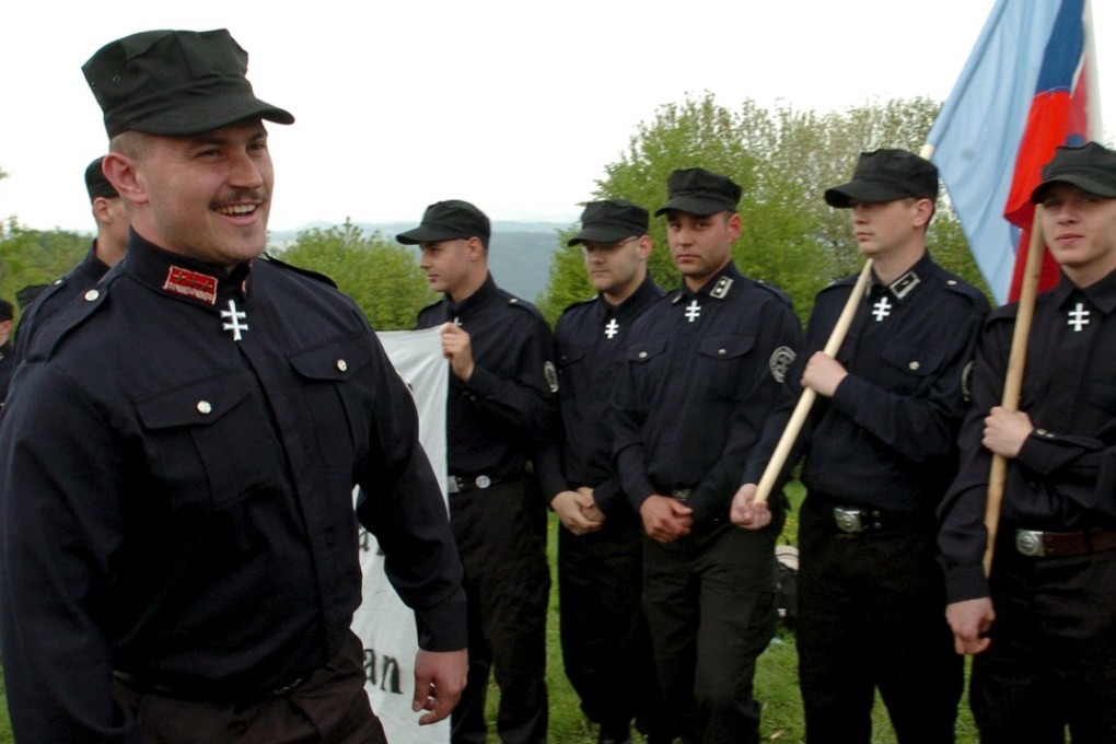 Members of the People's Party Our Slovakia group, led by Marian Kotleba (pictured), wear black uniforms reminiscent of Nazi-era collaborators. Photo: Reuters