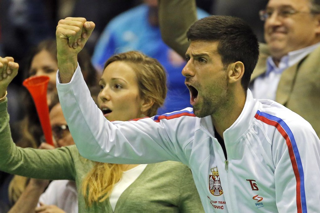 A watching Novak Djokovic celebrates a point for teammate Viktor Troicki against Kazakhstan's Aleksandr Nedovyesov during Serbia’s Davis Cup World Group first round triumph. Photo: Xinhua