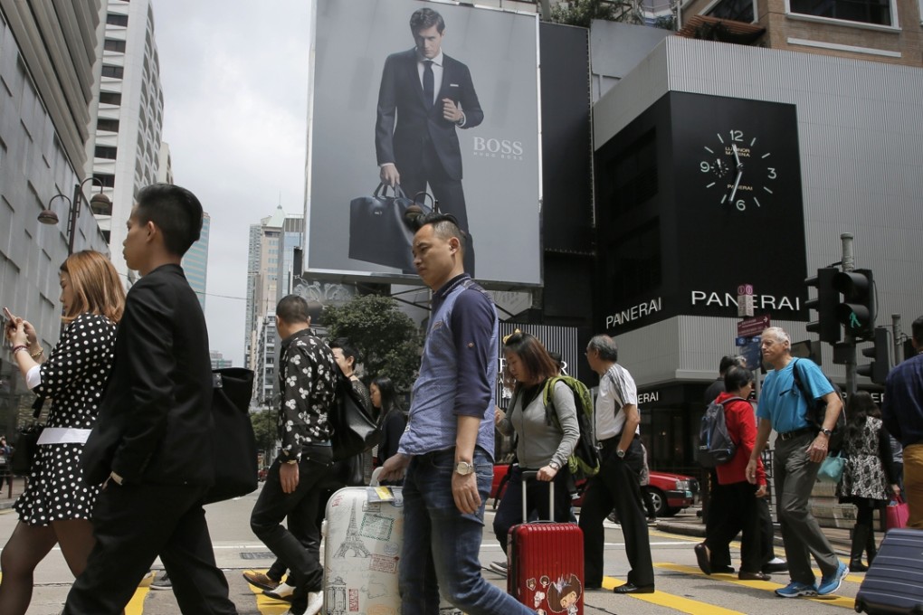 Mainland Chinese tourists with suitcases do the rounds of the shopping districts in Hong Kong. Photo: AP