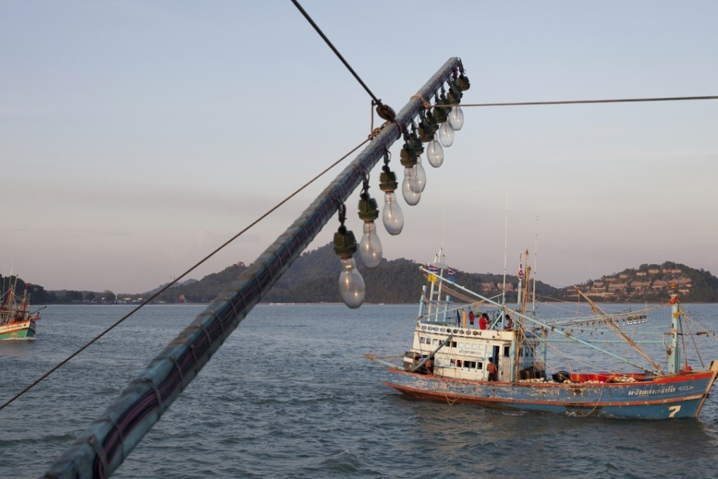 Fishing boats leave for the ocean at dusk. Photo: SCMP Pictures