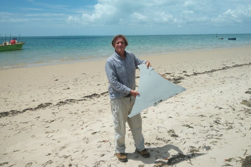 Blaine Gibson displays a piece of debris found on a Mozambique sandbar on February 27. The debris is thought to be consistent with a part from a Boeing 777. Flight MH370 is the only such aircraft to have gone missing. Photo: Blaine Gibson