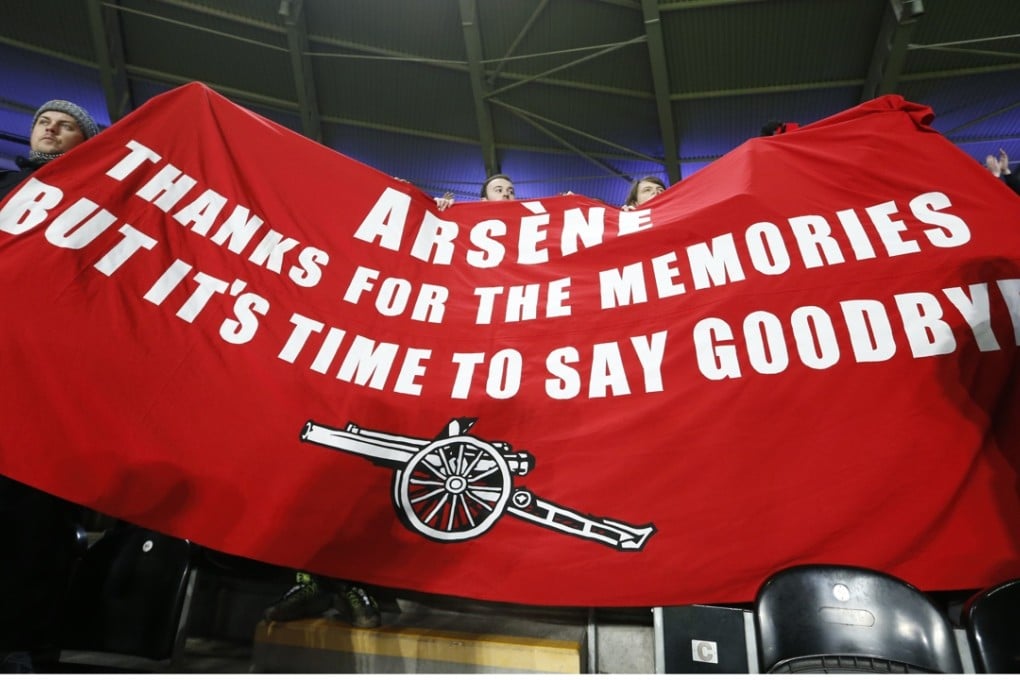 Arsenal fans with a banner directed at manager Arsene Wenger. Photo: Reuters