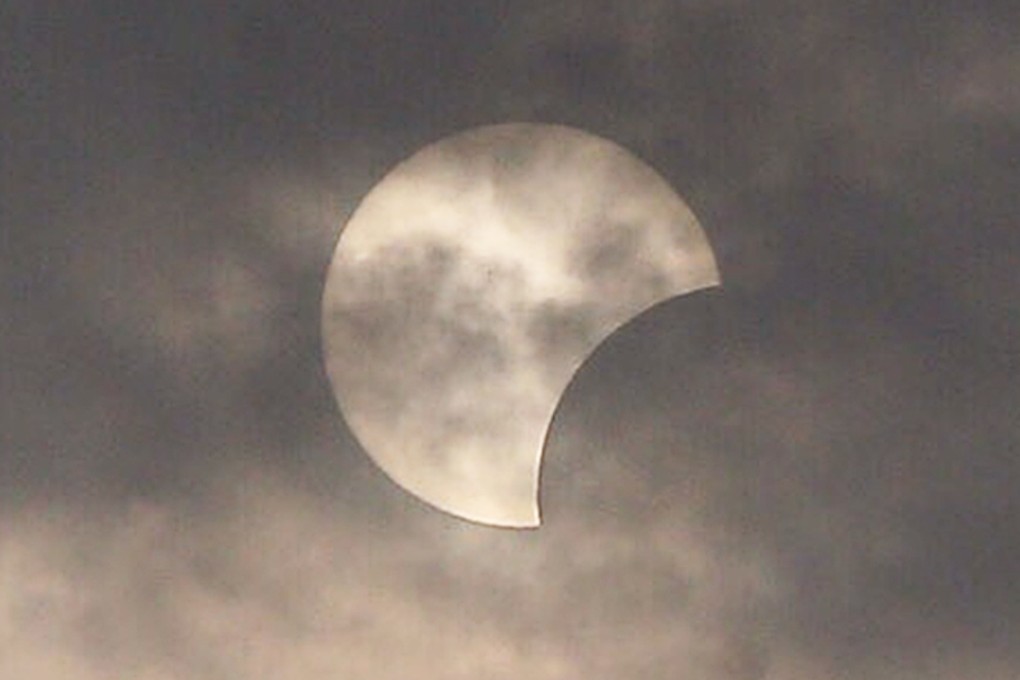 Hong Kong caught a glimpse of the partial eclipse through heavy cloud today. Photo: Dickson Lee