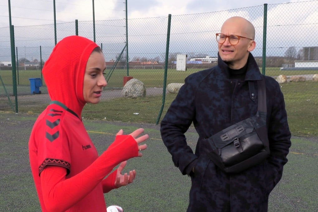 Afghani national soccer team player Shabnam Mabarz, left, wearing the new head-to-toe outfit with an integrated hijab, talks with Hummel CEO Christian Stadil in Copenhagen. Photo: AP