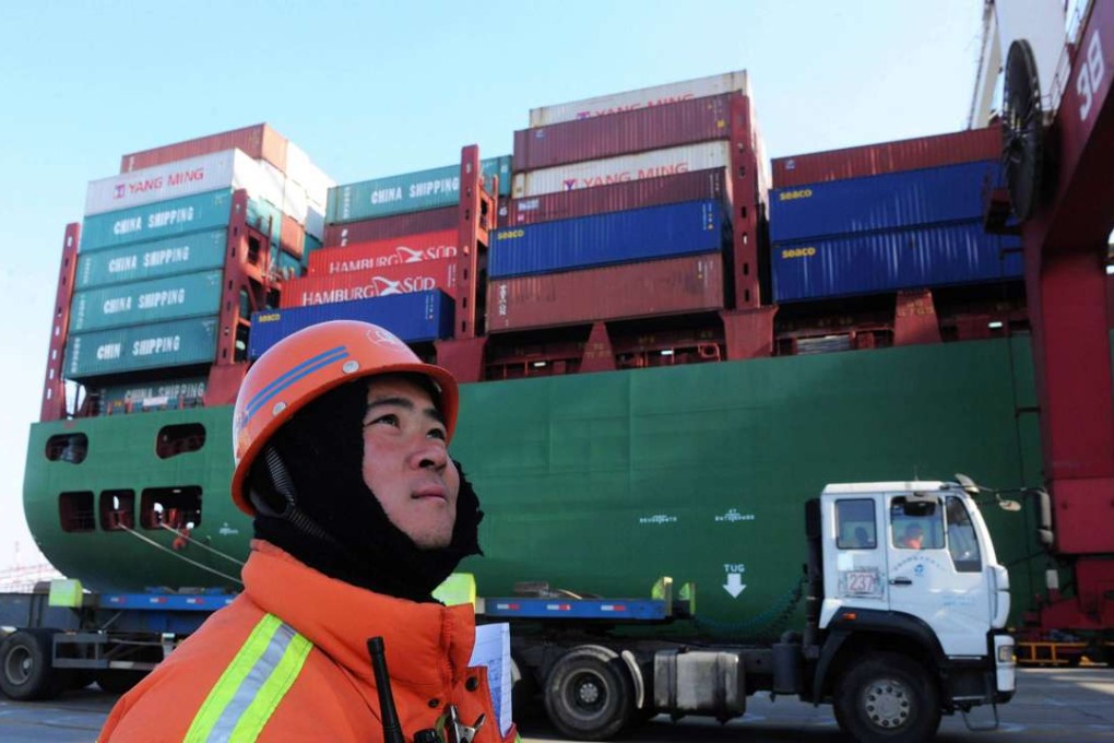 A worker watches over cranes at the port in Qingdao, in China's Shandong province. Chinese exports slumped by a quarter in February. Photo: AFP