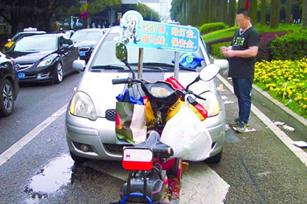 An electric bicycle is parked in front of a Toyota car in Zhangshan following the alleged revenge attack. Photo: Zhongshan Daily