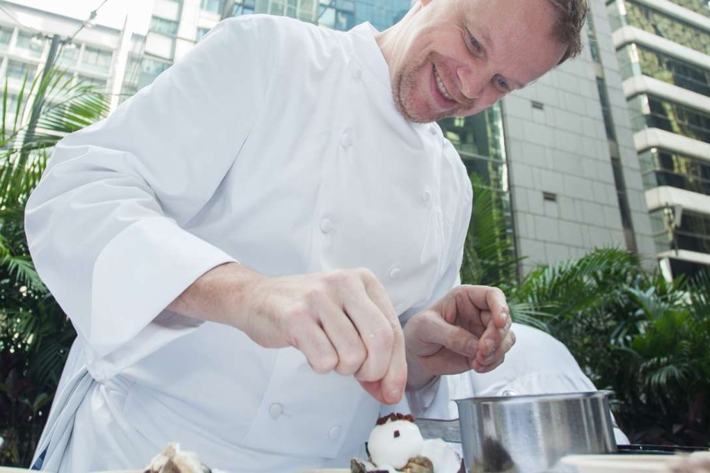 Chef Richard Ekkebus applies the finishing touches to a dish from Amber restaurant at Taste of Hong Kong.