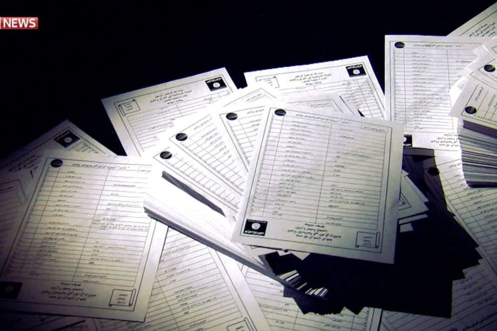 A video grab from footage released by Sky News on Thursday shows printed documents arranged for a report on a cache of leaked documents allegedly containing the personal details of some 22,000 Islamic State jihadists. Photo: AFP