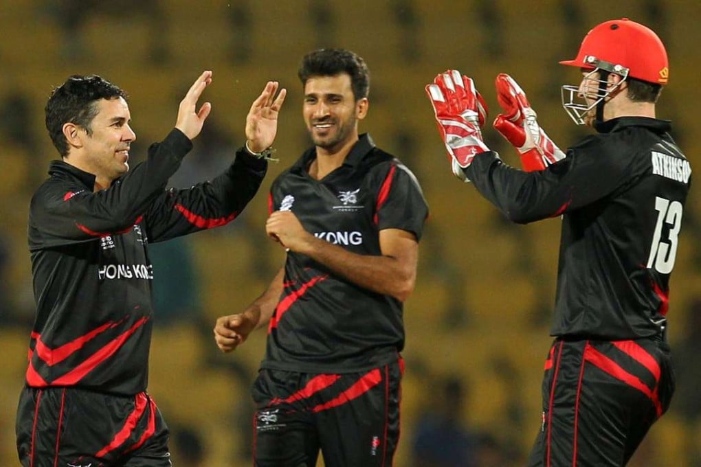 Ryan Campbell (left) celebrates with captain Tanwir Afzal and Jamie Atkinson after taking a wicket. Photo: AFP