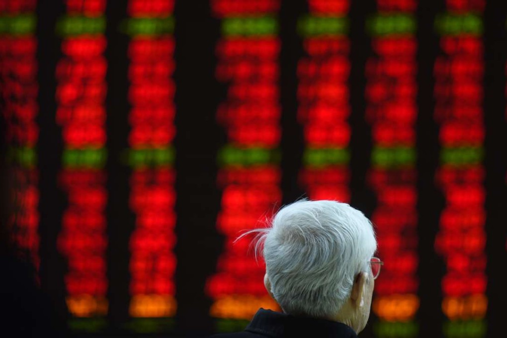 An investor watches stock movements on a screen at a securities company in Beijing. Photo: AFP