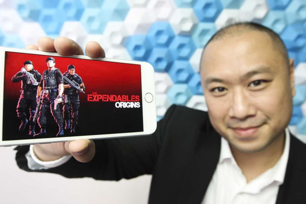 Eric Tan of Fifth Journey with smartphone game The Expendables Origins. Photo: Bruce Yan