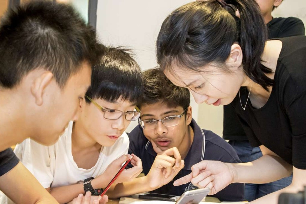 Michelle Sun (Right) Founder and CEO of First Code Academy teach students how to design an app at a programming school in Wan Chai. Photo: SCMP Pictures