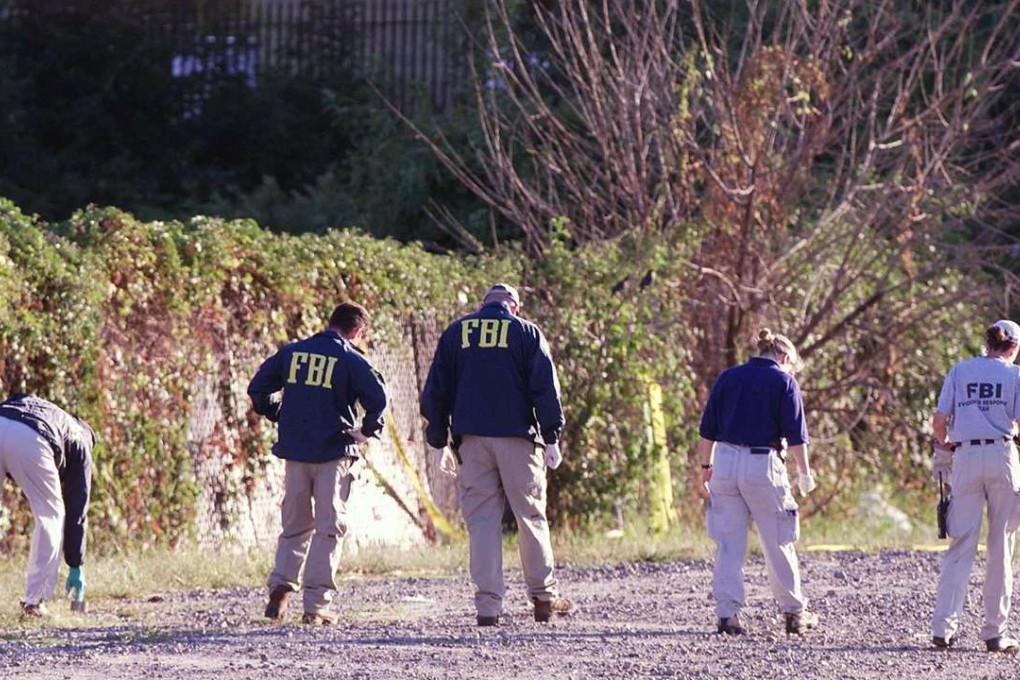 FBI agents form a human chain looking for evidence. Photo: AFP