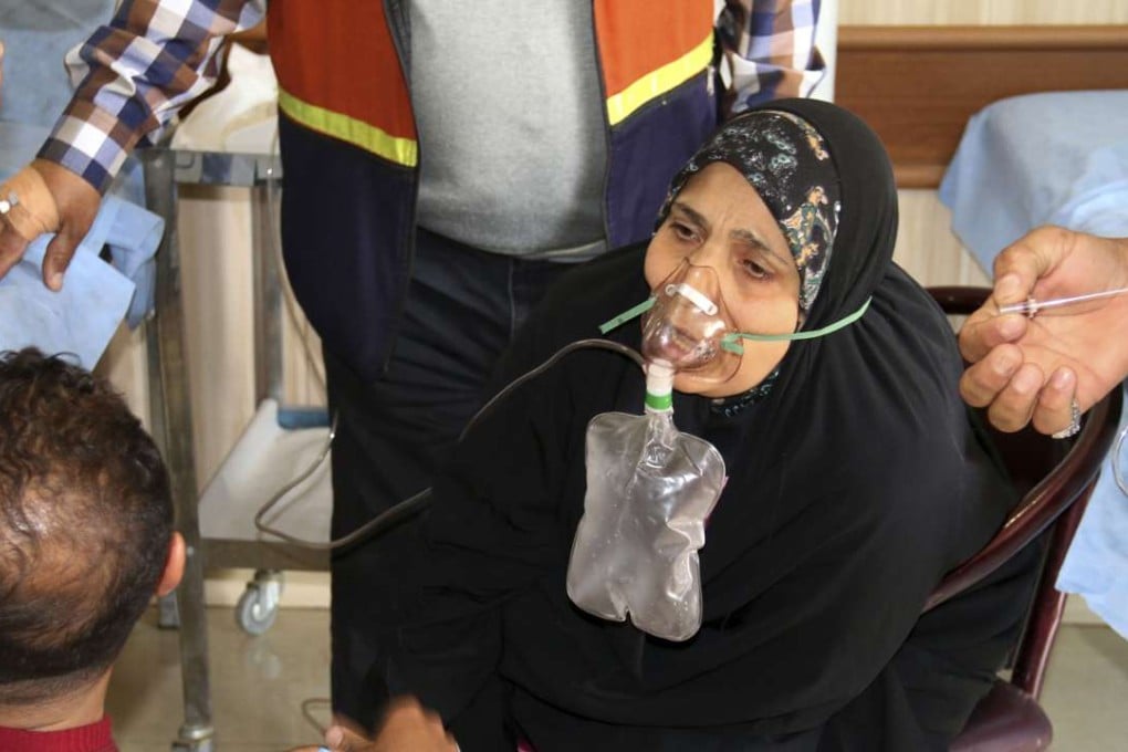 An elderly woman is treated after exposure to an apparent chemical attack near Kirkuk on Friday. Photo: AP