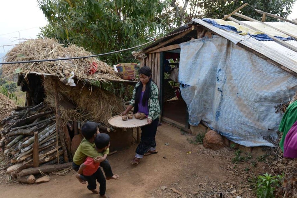 Nepalese migrant worker Sunita Magar with her children at their house in Dhadhing district, Nepal. Photo: AFP
