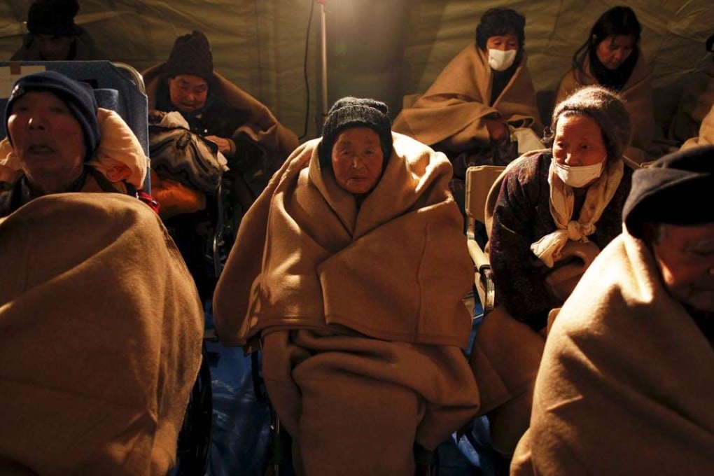 Elderly people with blankets after being evacuated from an area hit by the 2011 tsunami. Photo: Reuters