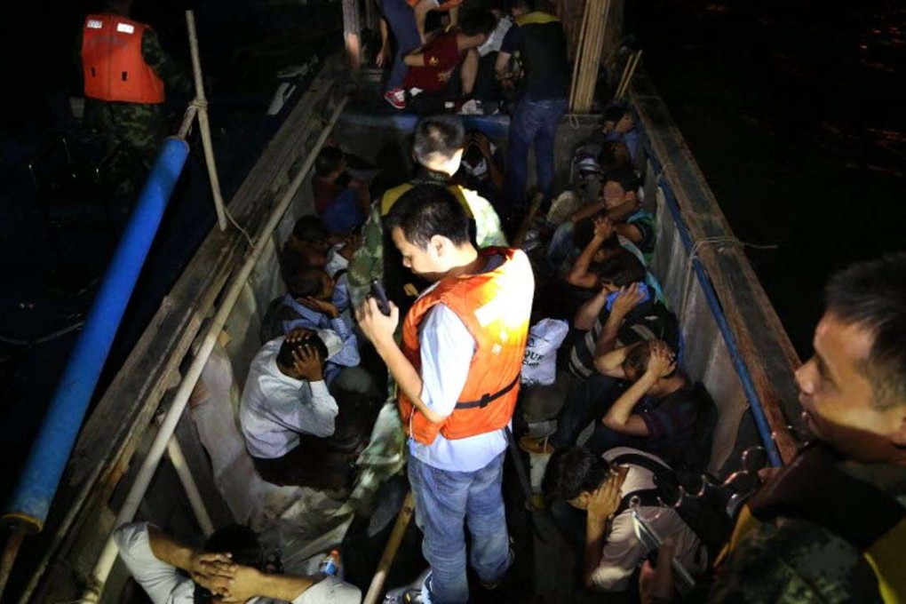 The border-control armed police check a human smuggling boat in the sea in China’s southern city Shenzhen. Photo: Xinhua