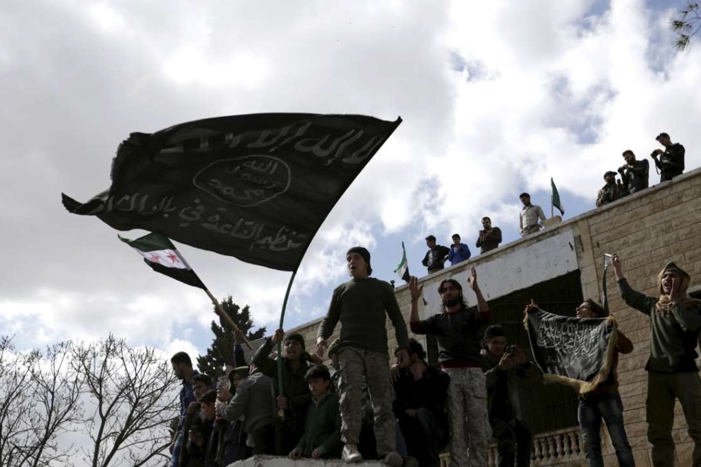 Protesters carry al-Qaeda flags during an anti-government protest in the town of Marat Numan. Photo: Reuters