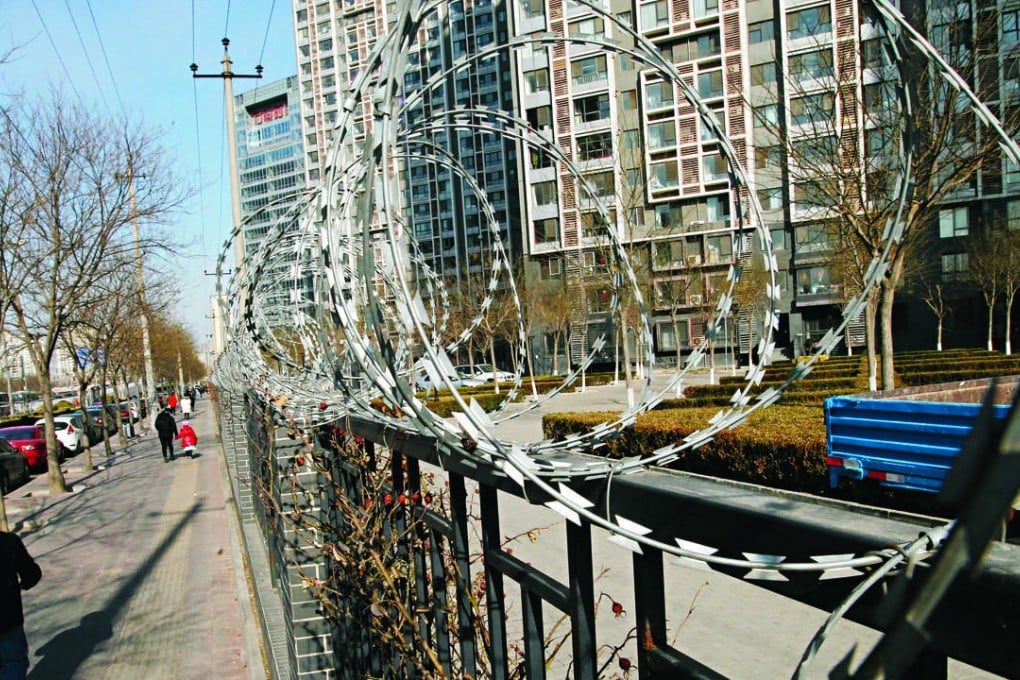 Bared wires ward off unwanted visitors at a a gated community in Wangjing in northern Beijing. Photo: Simon Song