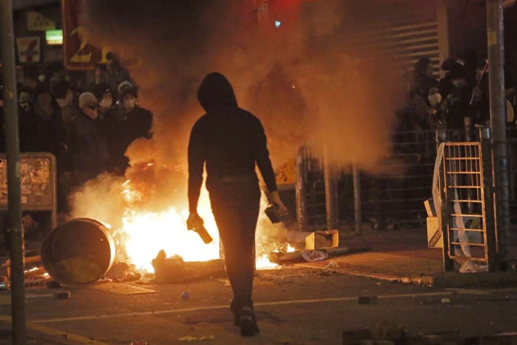 A rioter holds bricks during the disturbances in Mong Kok. While violence in social protests is never justified and nearly always self-defeating, there is now a clear obligation to understand and address its causes. Photo: AP