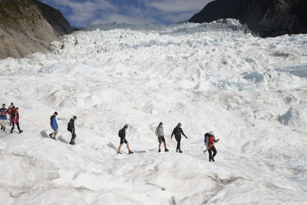 Tourists who have taken a helicopter trip onto the Fox Glacier in New Zealand in February follow a guide. The Fox and Franz Josef glaciers have been melting at such a rapid rate that it has become too dangerous for tourists to hike onto them from the valley floor, ending a tradition that dates back a century. Photos: AP