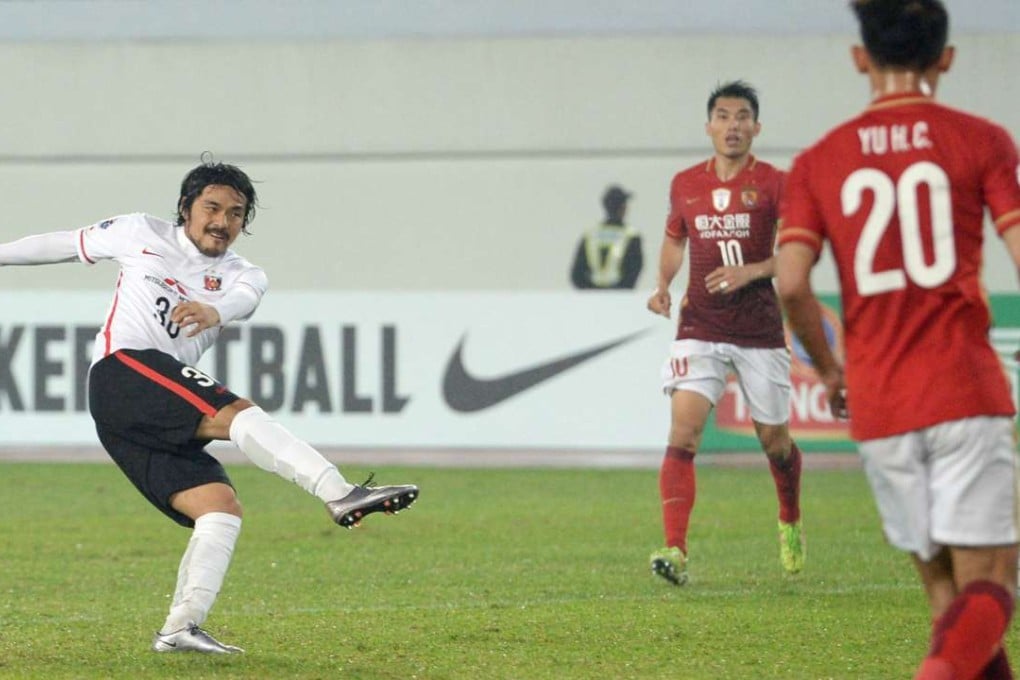 Urawa Reds’ Shinzo Koroki scores against defending champions Guangzhou Evergrande. Photo: Kyodo