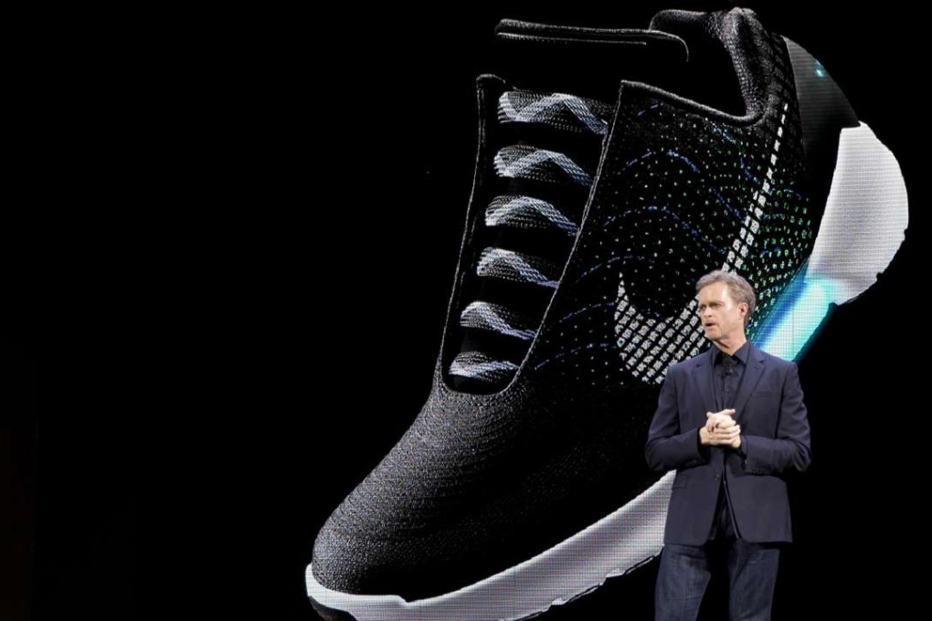An image of the Nike HyperAdapt 1.0 is projected on a screen as Nike CEO Mark Parker speaks during a news conference, on Wednesday in New York. Photo: AP