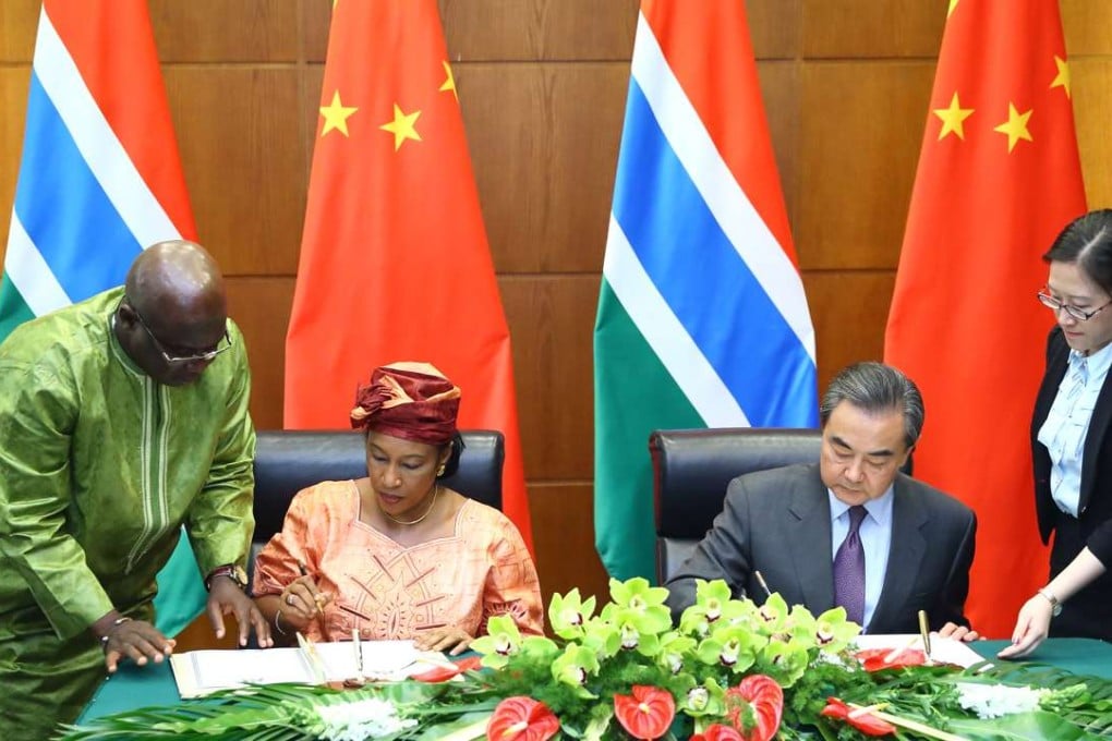 Gambian foreign minister Neneh Macdouall-Gaye (left) signs a communiqué with Chinese Foreign Minister Wang Yi resuming ties in Beijing on Thursday. Photo: Xinhua