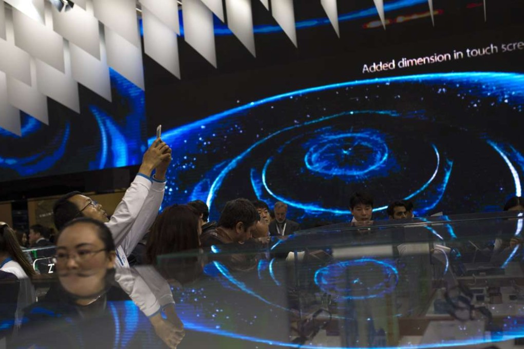 People look at smartphones and other devices displayed at ZTE’s stand during the Mobile World Congress Wireless show in Barcelona on February 23. Suppliers of goods subject to the US export curbs must now apply for a licence. Photo: AP