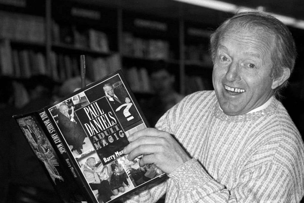 Photo of British magician Paul Daniels as he holds a copy of his book 'Adult Magic' in 1989. Photo: AP