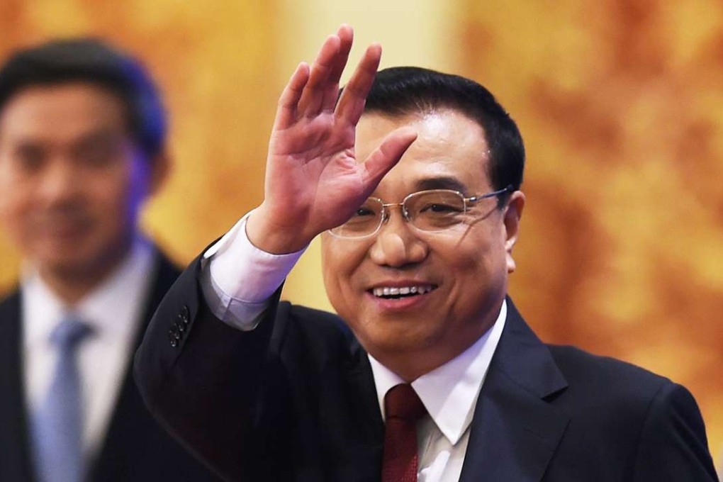 Chinese Premier Li Keqiang waves as he arrives for a press conference. Photo: AFP
