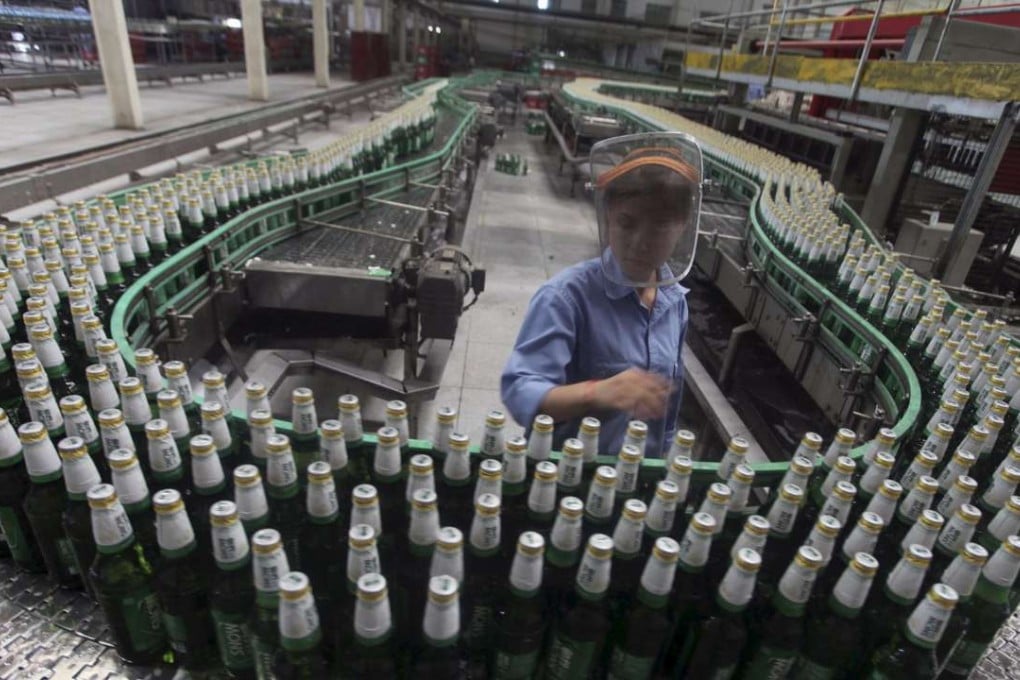 A labourer works at an assembly line in a factory of China Resources Snow Breweries in Lanzhou, Gansu province. Photo: Reuters