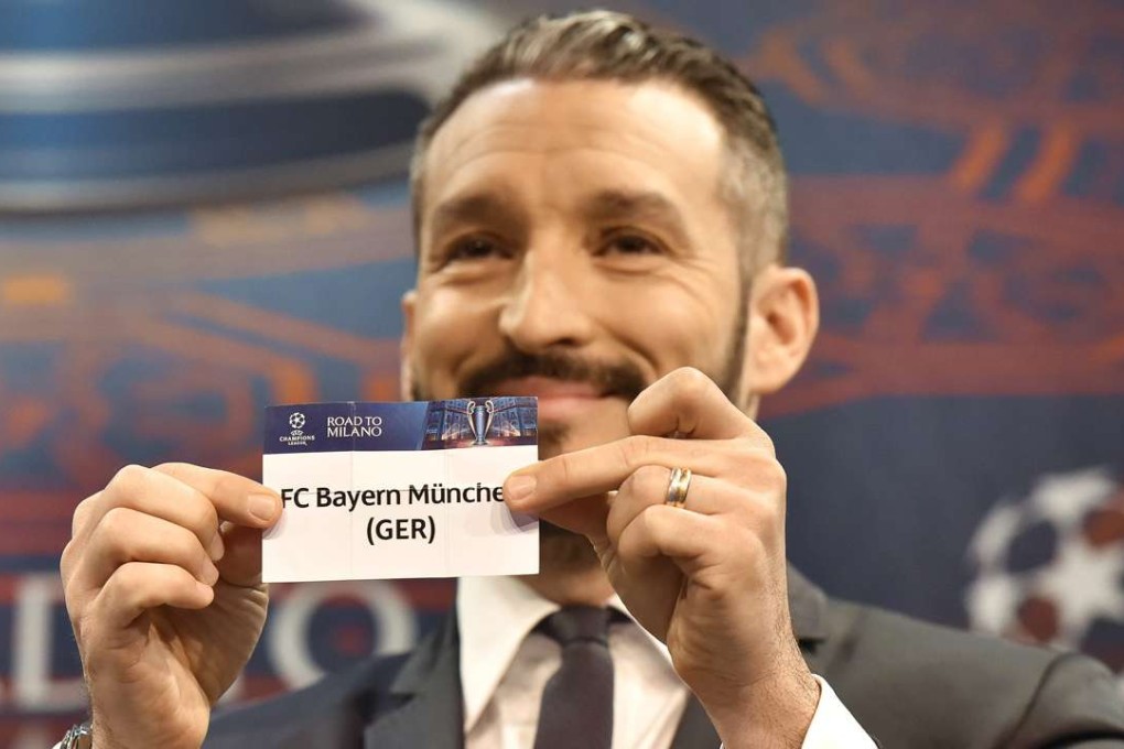Gianluca Zambrotta, ambassador for the 2016 Champions League final in Milan, shows the ticket of Bayern Munich during the draw for quarter-final matches. Photo: EPA