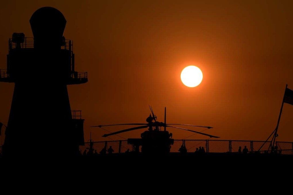 The sun sets behind US Navy ship USS Blue Ridge docked in Manila. Washington is boosting its military assistance to the Philippines. Photo: AFP