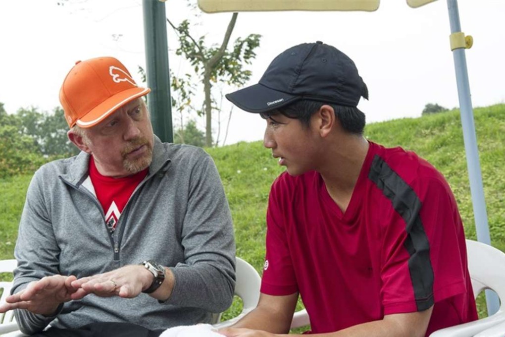 Former world No 1 Boris Becker gives tips to young Hong Kong Junior Davis Cup player Jonathan Zhang Zheng Qi during his visit at Mission Hills. Photos: SCMP Pictures