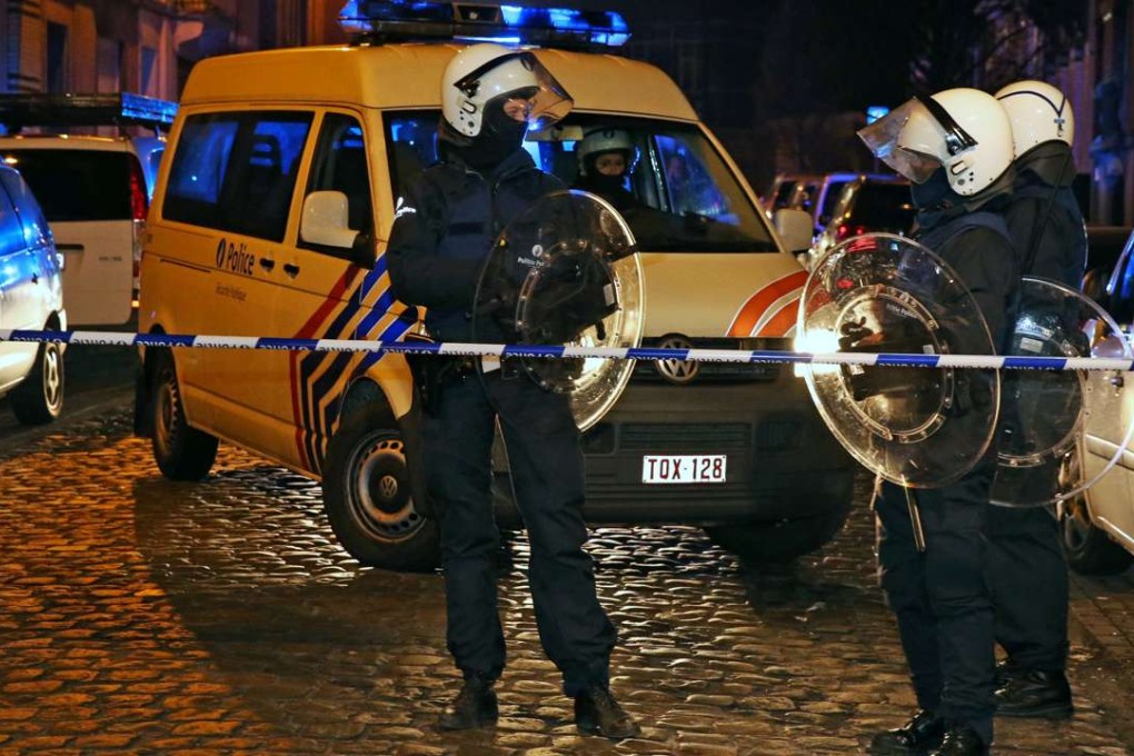 Belgian police forces during a police raid in the Molenbeek-Saint-Jean district in Brussels. Photo: AFP