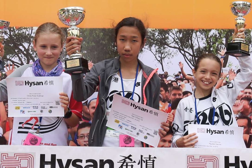 Yip Ngo-ching (centre) shows off her spoils after her victory in the women’s 5k run. Photo: SCMP Pictures